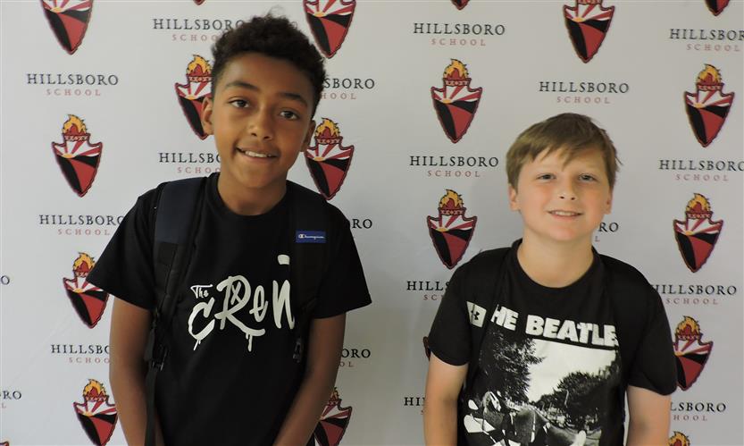Two students smile